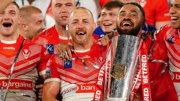 Captain James Roby holds the Super League trophy as Saints celebrate