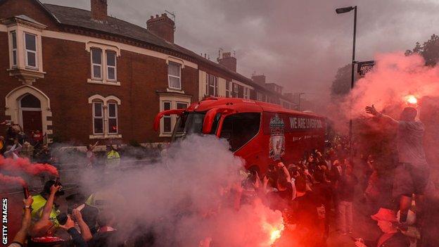 Liverpool fans lined the streets and let off smoke flares when the Liverpool team bus arrived