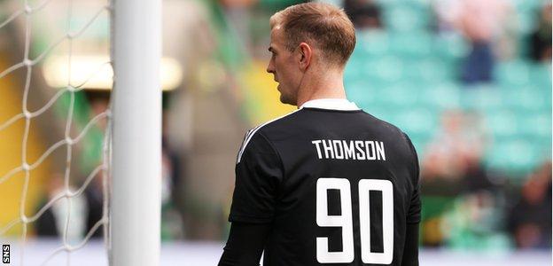 Joe Hart wearing a top that says 'Thomson 90' during Celtic's warm-up against Ross County