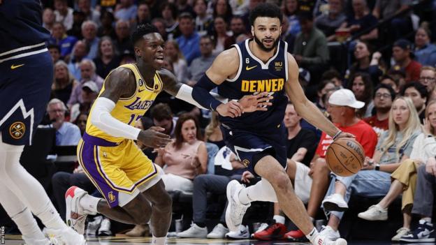 Jamal Murray controlling the ball against Los Angeles Lakers guard Dennis Schroder