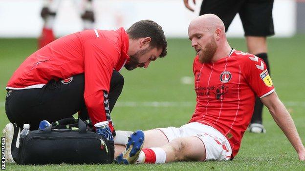Jonny Williams receives treatment for an injury
