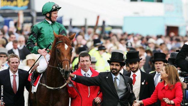 Sheikh Mohammed bin Rashed al-Maktoum, Vice President and Prime Minister of UAE and the ruler of Dubai, runs with his wife Princess Haya Bint al-Hussein of Jordan, his horse New Approach and jockey Kevin Manning after winning the derby at Epsom Derby on June 7, 2008 in Epsom, England.