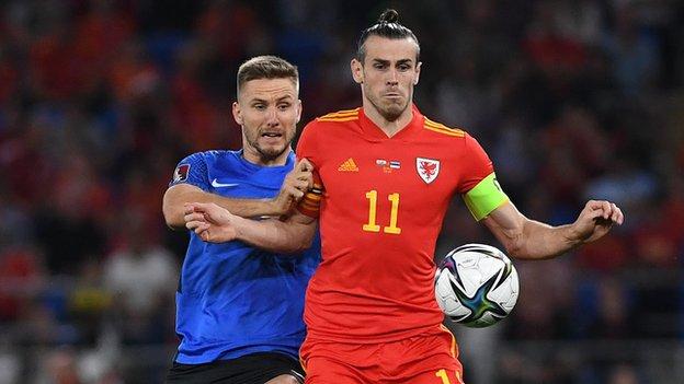 Gareth Bale's hair falls out of his man bun during Wales' draw