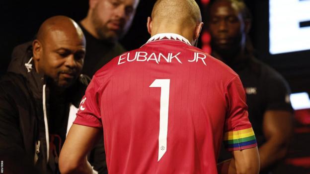 Picture of the back of Chris Eubank's Manchester United shirt with a rainbow armband
