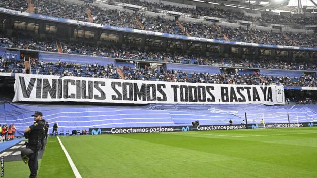 Real Madrid fans hold up a banner that says 