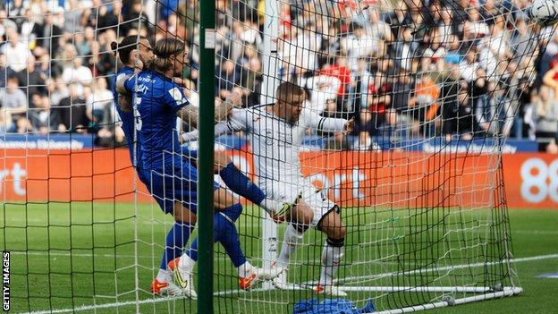 Jake Bidwell ends up in the net as he scores Swansea's third