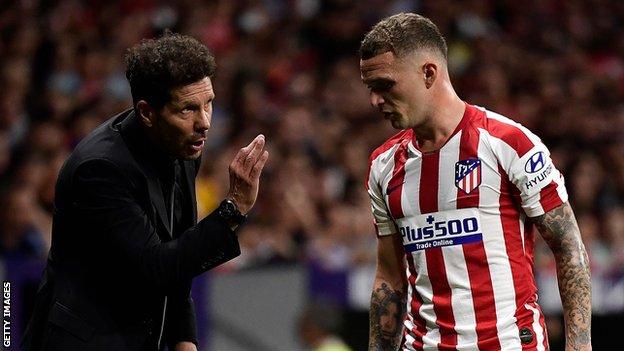 Diego Simeone gives Kieran Trippier instructions from the sidelines during play