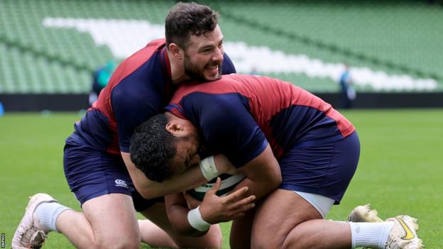 Robbie Henshaw grapples with fellow centre Bundee Aki in Thursday's opening training session at the Aviva Stadium