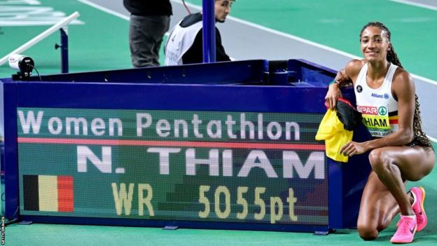 Nafi Thiam poses for a photo with her pentathlon world record at the European Indoor Championships