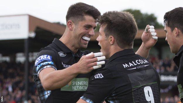 Adam Hastings and George Horne celebrate a try for Glasgow