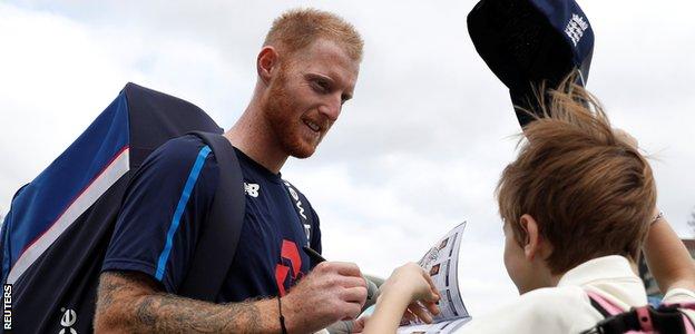 Ben Stokes signs an autographs for a young fan