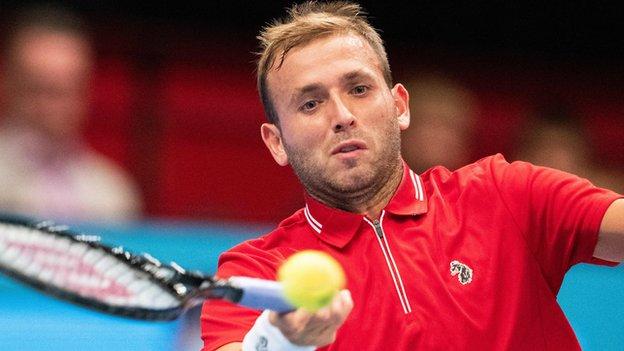 Dan Evans hits a return against Carlos Alcaraz in Vienna