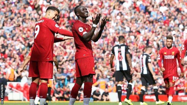 Liverpool's Sadio Mane celebrates with team-mate Roberto Firmino