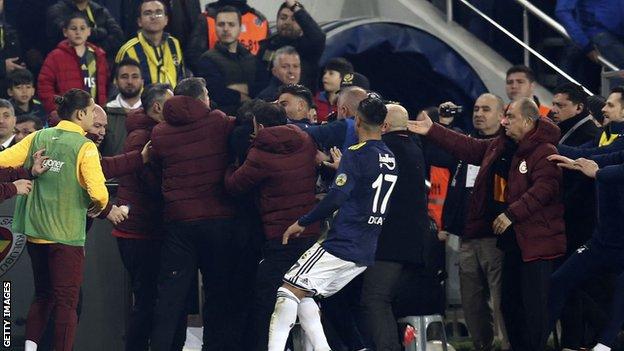 Fenerbahce and Galatasaray players clash on the touchline