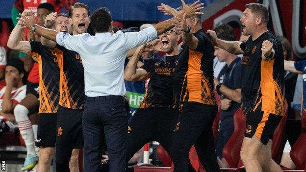 Rangers manager Giovanni van Bronckhorst and his staff erupt in joy as Rangers defeat PSV Eindhoven
