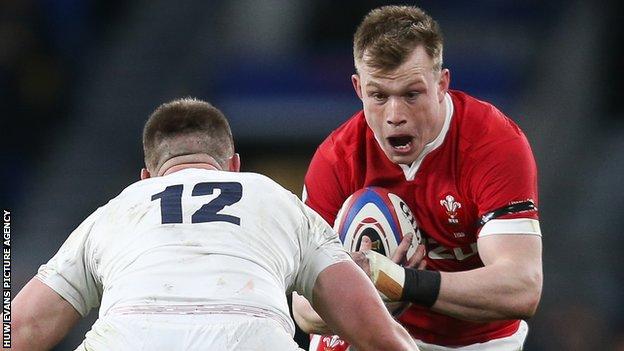 Wales' Nick Tompkins (right) takes on England captain Owen Farrell
