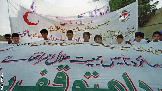 A group of Afghan children take part in a Red Cross procession in Mazar in 2000