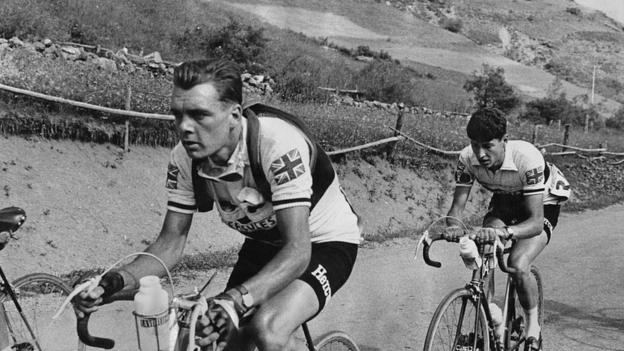 Cyclist Brian Robinson (left) competes in the Tour de France in 1955