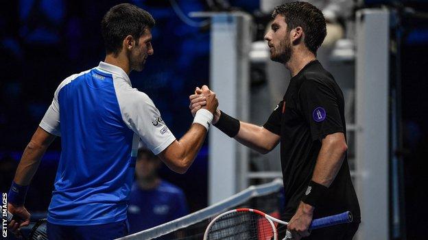 Novak Djokovic and Cameron Norrie shake hands at the net