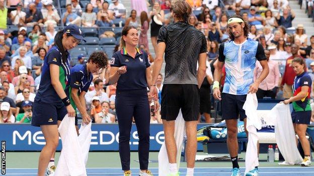 The court being cleaned after Lloyd Harris spilt his drink