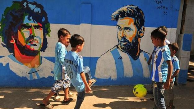 Young Argentina football fans playing on streets of Sylhet, Bangladesh.