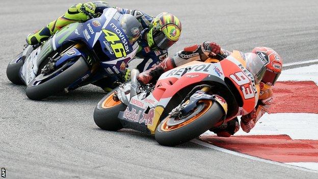 Valentino Rossi (left) battles for position with Marc Marquez
