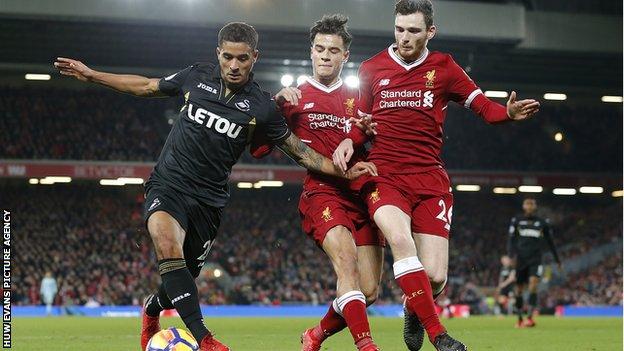 Coutinho and Robertson attempt to rob Kyle Naughton of the ball when the sides met on Boxing Day