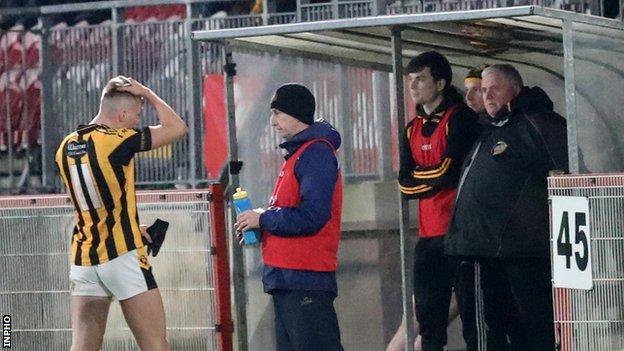 Crossmaglen's Rian O'Neill walks to the dugout after his straight red card at Healy Park
