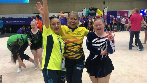 Ellie-Bea Thomas smiling and dancing astatine  the Special Olympics gymnastics