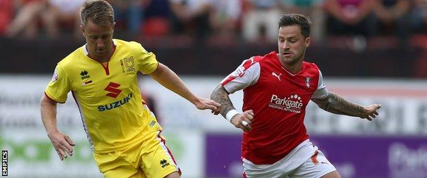 MK Dons goalscorer Dean Bowditch is challenged by Rotherham United's Chris Maguire