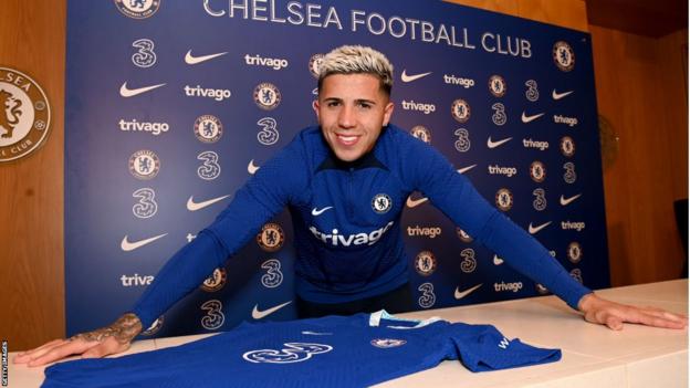 Enzo Fernandez posing with a Chelsea shirt after his £107m move from Benfica