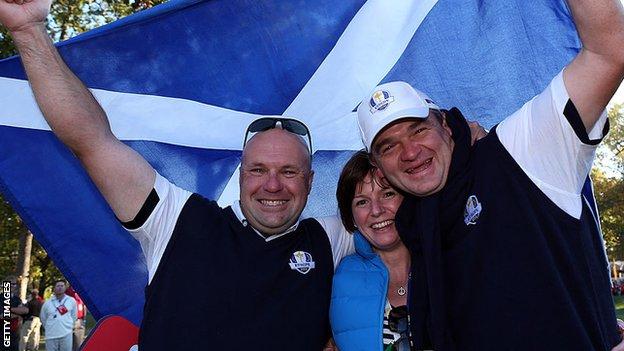 Paul Lawrie, right, celebrates winning Europe with his wife Marian and caddy David Kenny