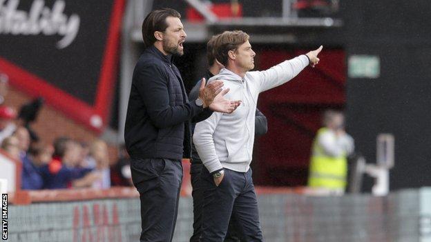 Russell Martin (left) took charge of MK Dons' EFL Cup defeat at Bournemouth on Saturday amid speculation over his future