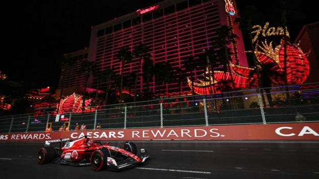 Charles Leclerc is racing round the circuit under the lights in Las Vegas.