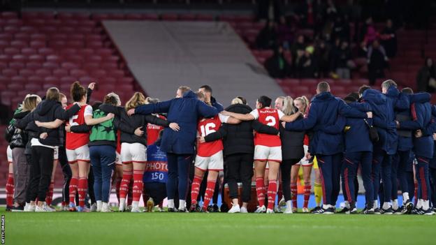 Arsenal players and manager in a huddle post match