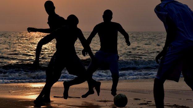 Boys playing football in Gabon