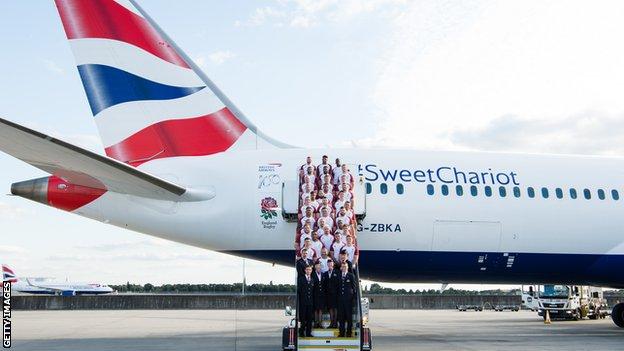 England's men's side stand on the steps of a British Airways plane with the England Rugby logo and the words #SweetChariot