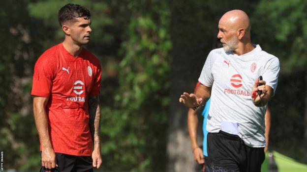 Christian Pulisic (L) of AC Milan speaks with Stefano Pioli Head manager  of AC Milan (R) during AC Milan grooming  session