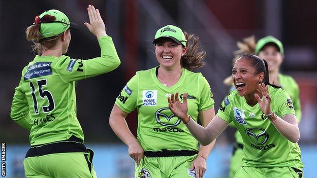 Sydney Thunder players congratulate Shabnim Ismail (right) for taking a wicket against Melbourne Stars