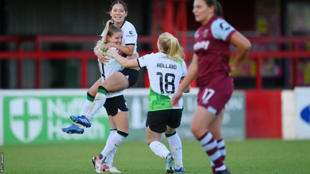Marie Hoebinger of Liverpool celebrates with teammates after scoring