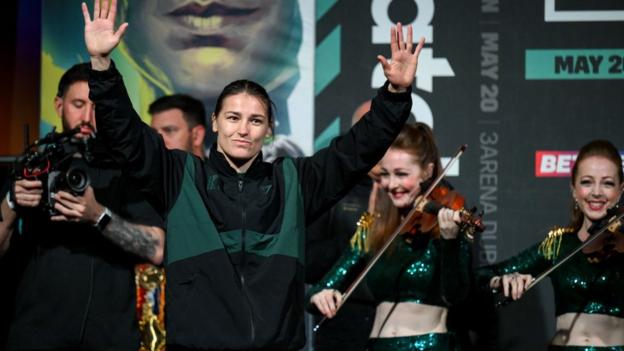 Katie Taylor waves to the crowd at a weigh-in