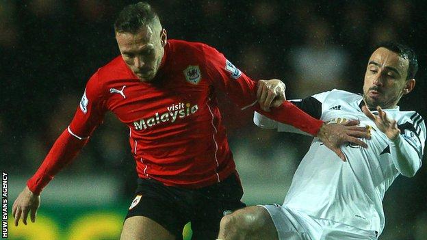 Craig Bellamy and Leon Britton compete against each other in February, 2014