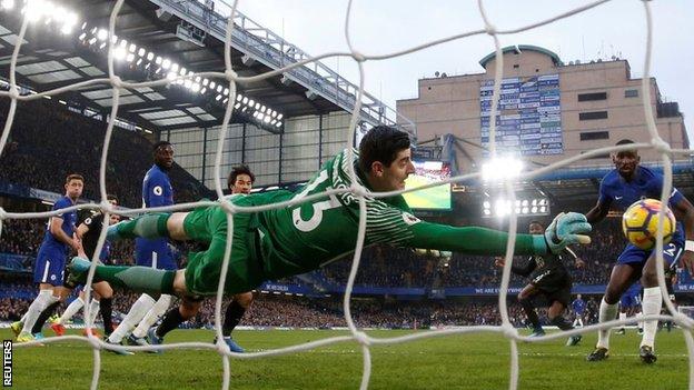 Chelsea keeper Thibaut Courtois makes a save against Leicester