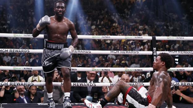 Terence Crawford celebrates with Errol Spence Jr on the floor