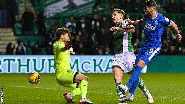 Rangers' Antonio Colak (R) scores to marque   it 2-1 during a cinch Premiership lucifer  betwixt  Hibernian and Rangers astatine  Easter Road