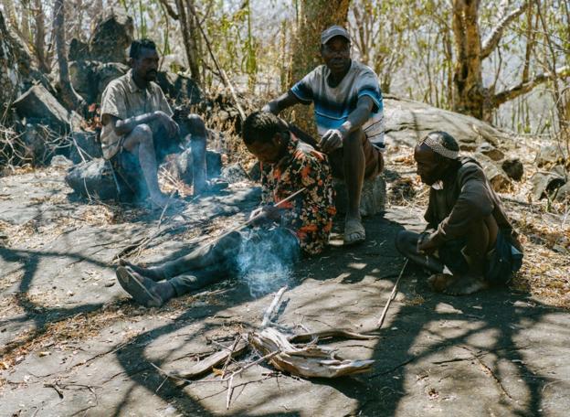 Hadza members build a fire