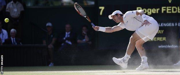 Andy Murray returns a ball against Roger Federer