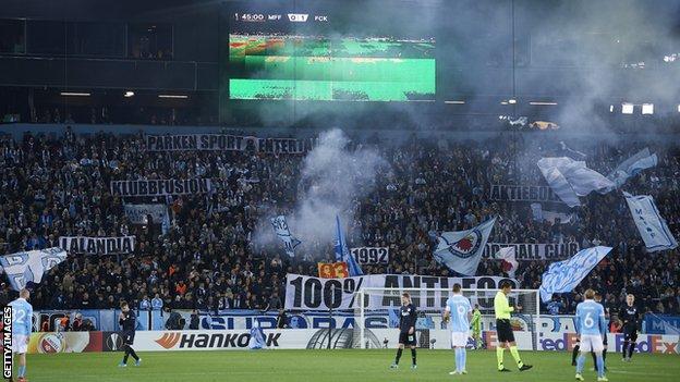 Malmo fans display banners during their first competitive match against Copenhagen in October