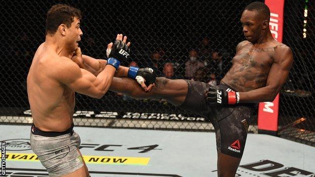 Nigeria-born Israel Adesanya (right) lands a kick on Paulo Costa at UFC 253