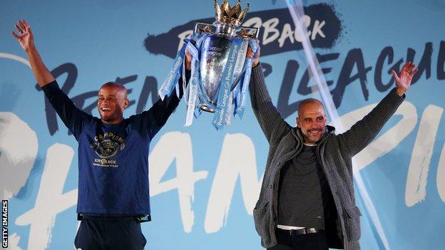 Kompany and Pep Guardiola lift the Premier League trophy aloft outside Etihad Stadium